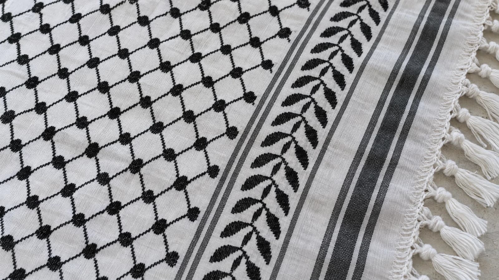 Close-up comparison of the net-like weave, wavy lines, and border stripes on a keffiyeh